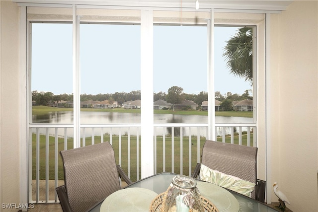 sunroom with a healthy amount of sunlight and a water view