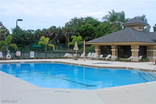 view of pool featuring a patio area and a hot tub