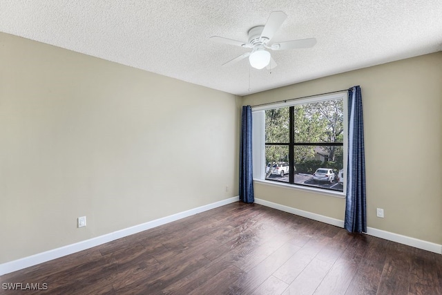 unfurnished room with a textured ceiling, a ceiling fan, baseboards, and wood finished floors