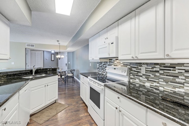 kitchen with white cabinets, hanging light fixtures, dark hardwood / wood-style flooring, sink, and white appliances