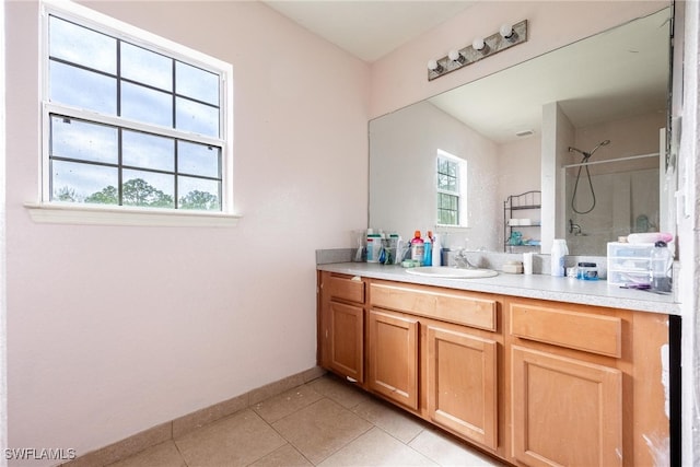 bathroom with vanity, a shower, and tile patterned flooring