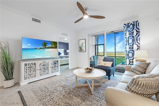 tiled living room featuring ornamental molding and ceiling fan