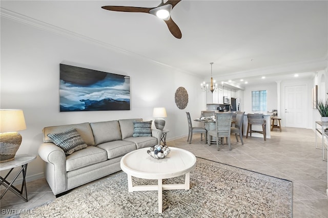 living room with ornamental molding, ceiling fan with notable chandelier, and light tile patterned floors