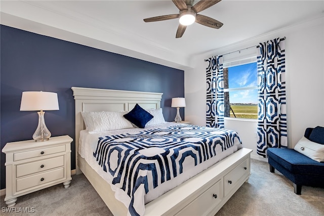 bedroom featuring ornamental molding, light colored carpet, and ceiling fan