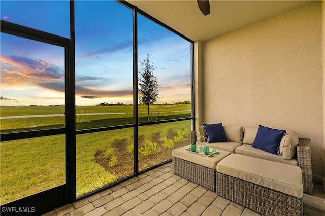 sunroom featuring ceiling fan