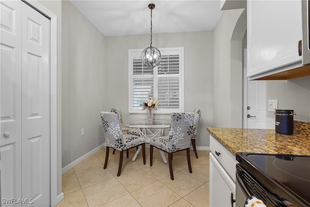 dining room featuring a chandelier and light tile patterned floors