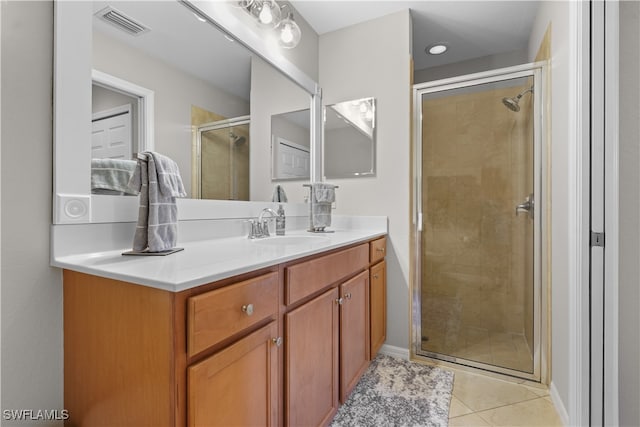 bathroom featuring tile patterned flooring, vanity, and a shower with shower door