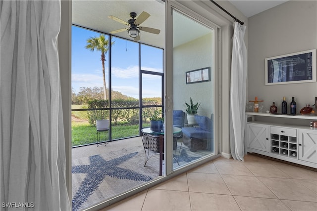 doorway to outside featuring light tile patterned flooring and ceiling fan