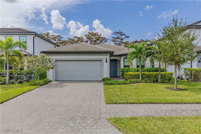 view of front facade featuring a front yard and a garage