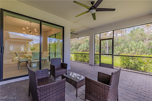 sunroom / solarium featuring ceiling fan