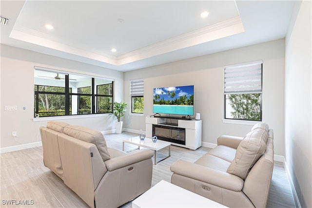 living room featuring crown molding and a tray ceiling