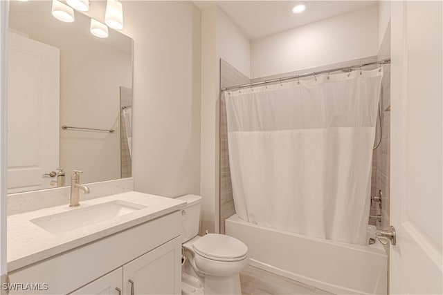 full bathroom featuring vanity, toilet, and shower / bathtub combination with curtain