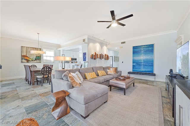 living room with rail lighting, crown molding, and ceiling fan