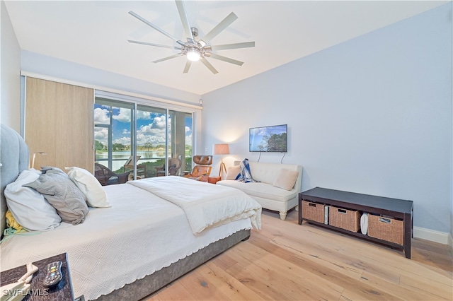 bedroom featuring light hardwood / wood-style flooring, access to exterior, and ceiling fan