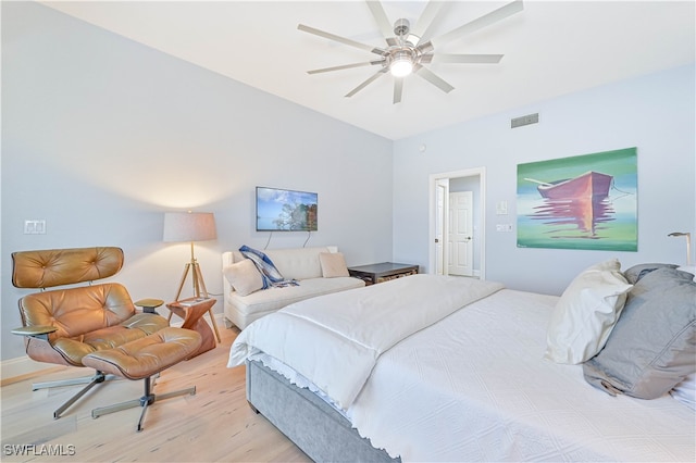 bedroom with light hardwood / wood-style floors and ceiling fan