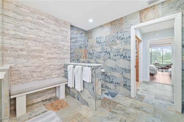 bathroom with tile walls