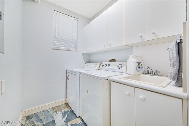 laundry area featuring sink, independent washer and dryer, and cabinets