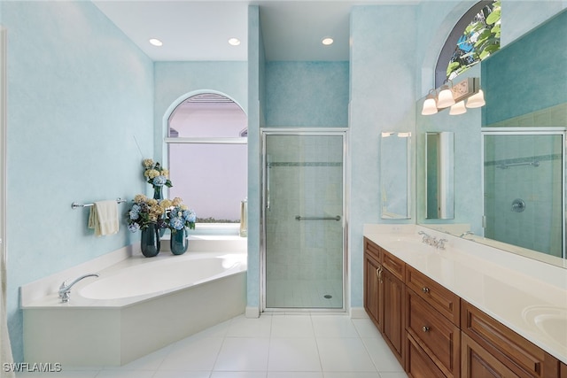 bathroom featuring tile patterned flooring, vanity, and separate shower and tub