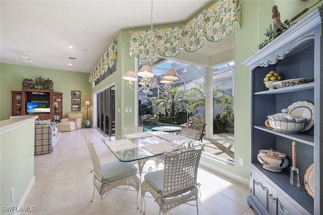 dining area with ceiling fan with notable chandelier and light tile patterned floors