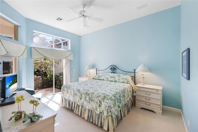 bedroom with ceiling fan, access to exterior, and light carpet