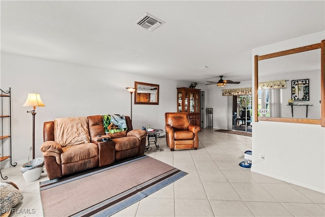 living room featuring ceiling fan and light tile patterned floors