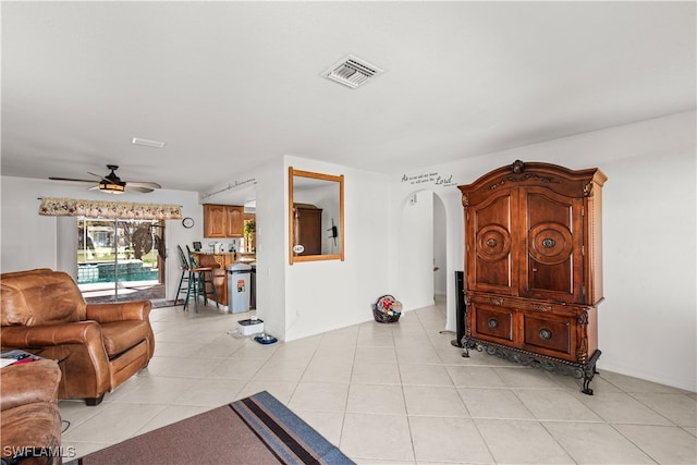 tiled living room with ceiling fan