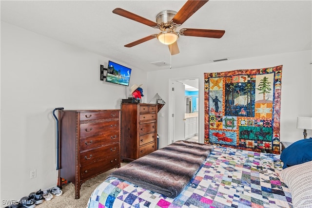 bedroom featuring connected bathroom, ceiling fan, and light colored carpet