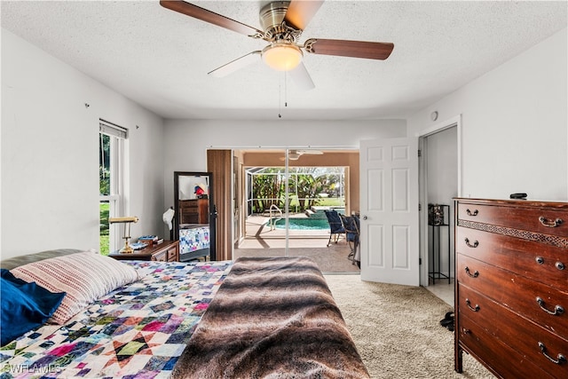 bedroom featuring a textured ceiling, access to exterior, light colored carpet, and ceiling fan