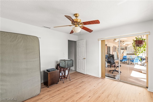 office area featuring light hardwood / wood-style floors, a textured ceiling, and ceiling fan