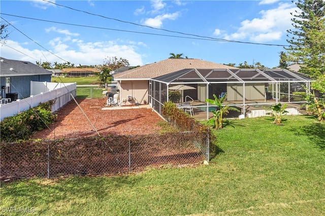 back of property with a patio area, a lanai, and a yard