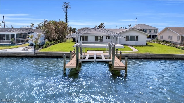 dock area with a water view and a lawn