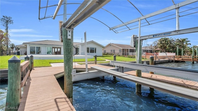 dock area featuring a water view and a yard