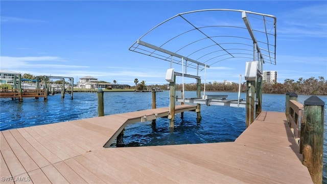 view of dock featuring a water view and boat lift