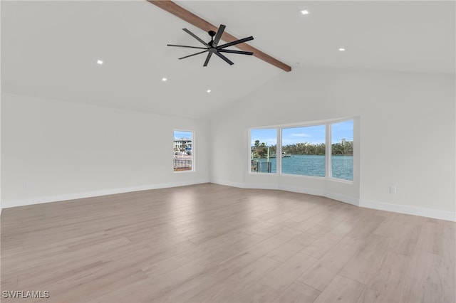 unfurnished living room with beamed ceiling, a water view, ceiling fan, high vaulted ceiling, and light wood-type flooring