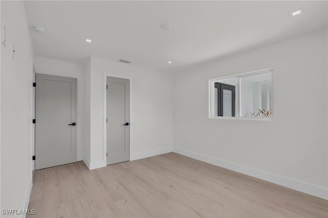 spare room with light hardwood / wood-style flooring