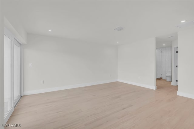 unfurnished room with light hardwood / wood-style floors