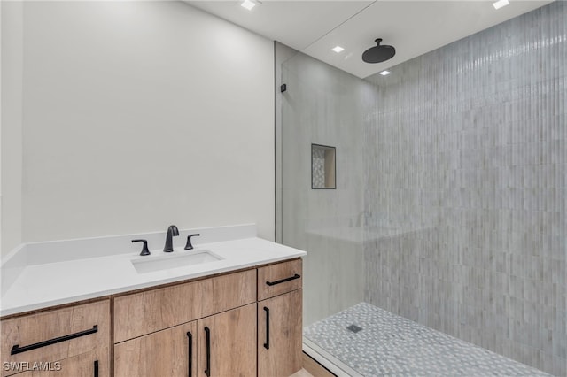 bathroom featuring vanity and a tile shower