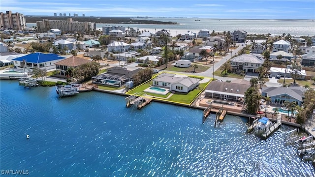 birds eye view of property with a water view and a view of city