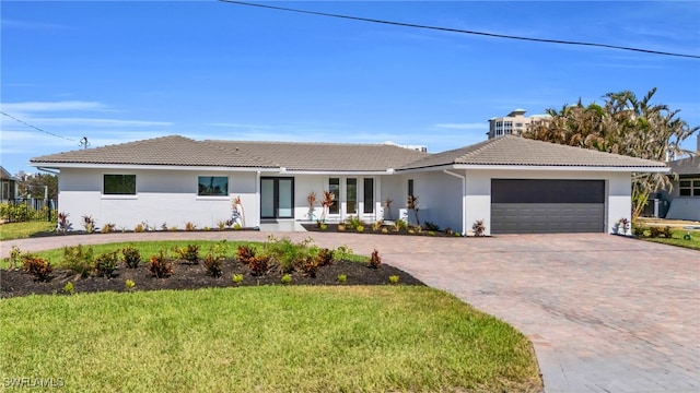 ranch-style house with a garage and a front yard