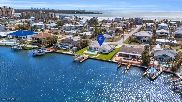 birds eye view of property with a water view