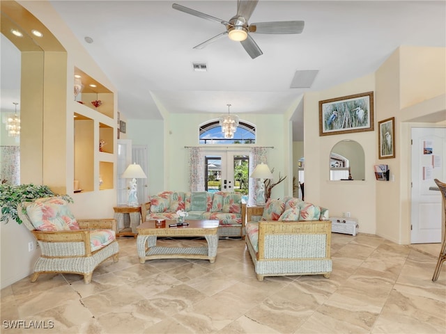 living room featuring french doors and ceiling fan with notable chandelier