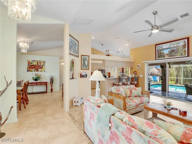 tiled living room with ceiling fan with notable chandelier and lofted ceiling