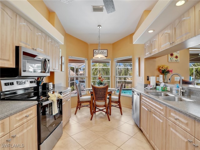 kitchen featuring pendant lighting, light brown cabinetry, sink, appliances with stainless steel finishes, and light tile patterned floors