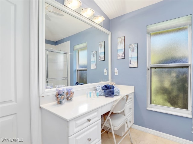 bathroom with tile patterned flooring, an enclosed shower, and vanity