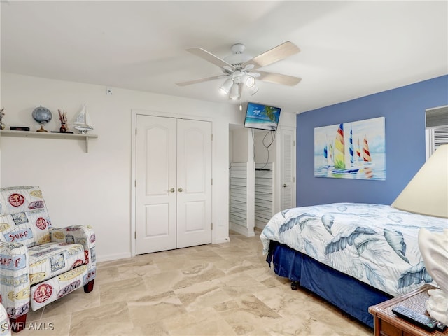 bedroom with ceiling fan and a closet