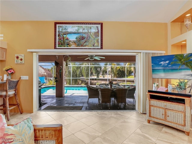 interior space with ceiling fan and tile patterned flooring