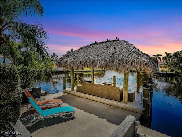 dock area with an outdoor hangout area, a gazebo, and a water view