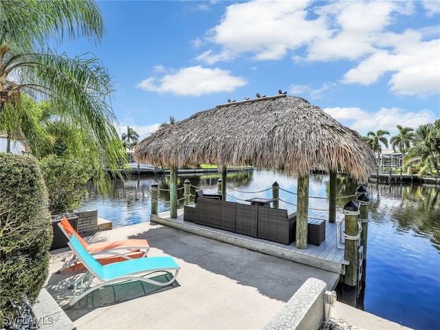 dock area featuring a water view, a gazebo, and an outdoor living space