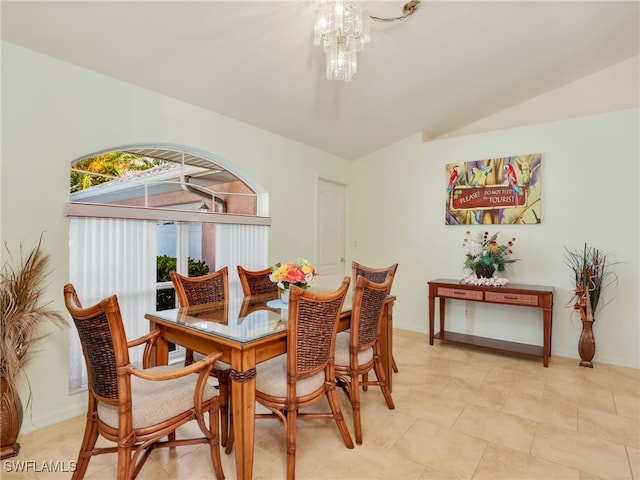 dining space with an inviting chandelier, lofted ceiling, and light tile patterned flooring