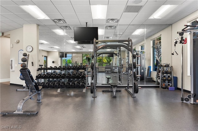 gym with a paneled ceiling